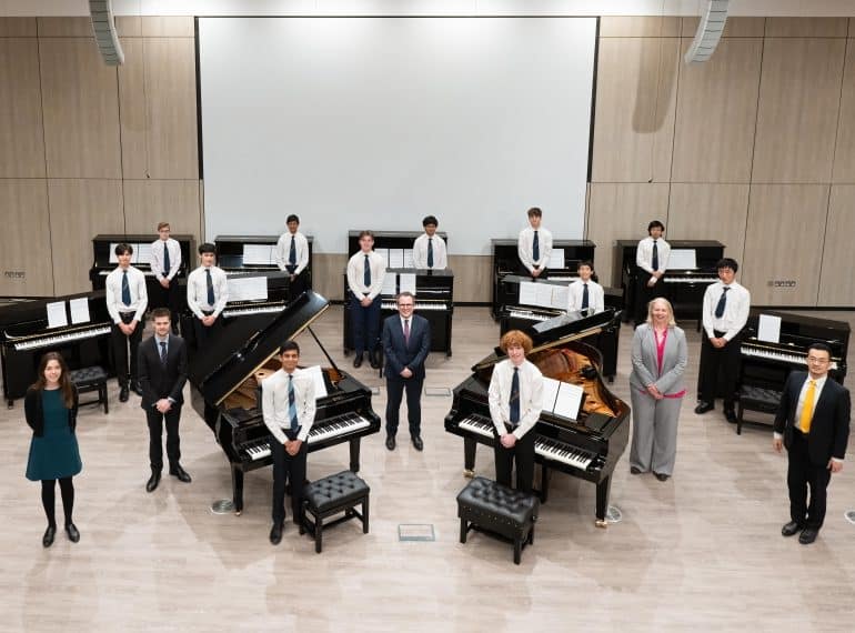 The magnificent dozen! QE’s leading pianists take to the keyboards to celebrate the arrival of new instruments